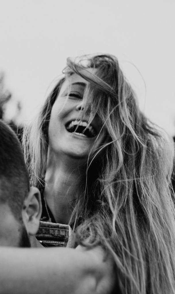 Lachende Frau auf Rücken des Freundes